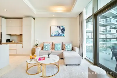 a living room with a couch and a table at LUX - The Elegant Palm Beach Suite in Dubai