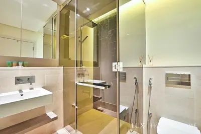 a bathroom with a glass shower and a sink at LUX - The Elegant Palm Beach Suite in Dubai