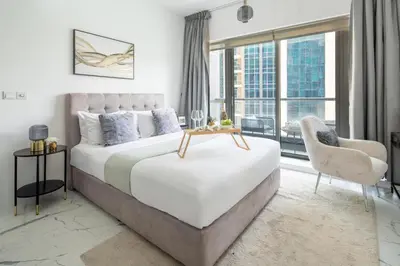 a bedroom with a bed and a large window at Frank Porter - The Point in Dubai