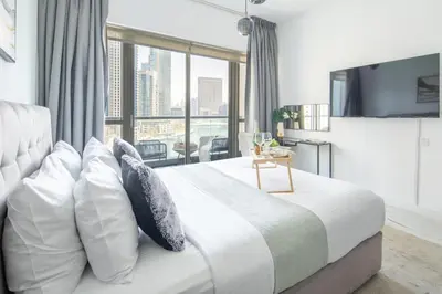a bedroom with a large white bed with pillows at Frank Porter - The Point in Dubai
