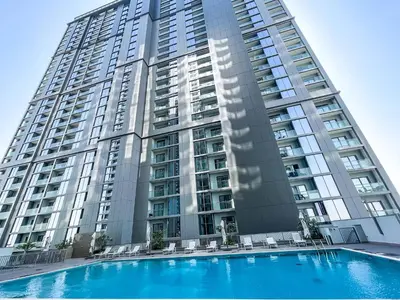 a large building with a swimming pool in front of it at STAY BY LATINEM Luxury 2BR Holiday Home CV B2513 near Burj Khalifa in Dubai