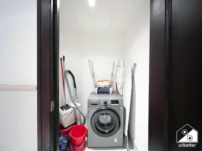 a washing machine in a corner of a room at Luxury 2Bedroom in Dubai Old Town with Burj View in Dubai