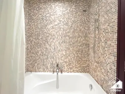 a bathroom with a bath tub with a shower at Luxury 2Bedroom in Dubai Old Town with Burj View in Dubai