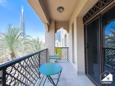 a balcony with a blue table and a view of the city at Luxury 2Bedroom in Dubai Old Town with Burj View in Dubai