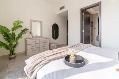 a bedroom with a large bed with a table on it at GuestReady - Stylish Apt in Business Bay in Dubai