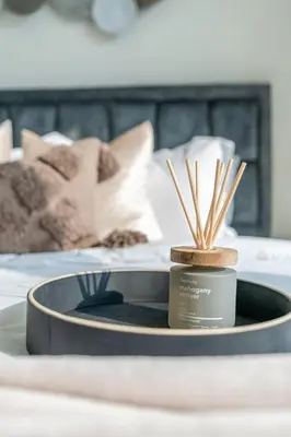 a tray with a candle on top of a bed at GuestReady - Stylish Apt in Business Bay in Dubai