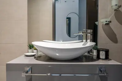 a bathroom with a white bowl sink on a counter at GuestReady - Stylish Apt in Business Bay in Dubai