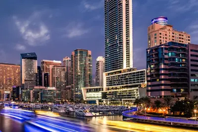 a city skyline with tall buildings and a river with boats at Vida Dubai Marina & Yacht Club in Dubai