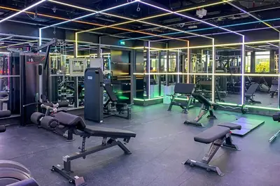 a gym with several treadmills and machines in a room at Frank Porter - Regina Tower in Dubai