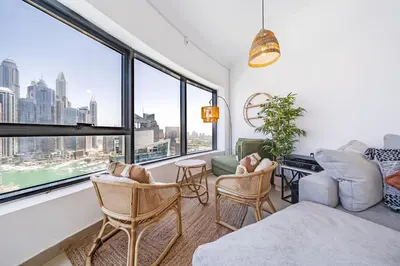 a living room with a view of the city at Spacious 3BR with 180˚ Dubai Marina Views in Dubai