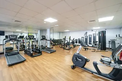 a gym with several treadmills and exercise bikes at Spacious 3BR with 180˚ Dubai Marina Views in Dubai