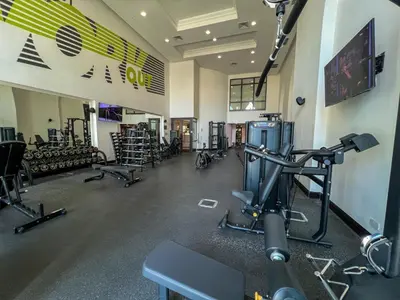 a gym with a lot of treadmills and machines at Durrani Homes - Heaven on Earth in Dubai