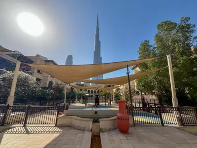 a canopy over a fountain in a park at Durrani Homes - Heaven on Earth in Dubai