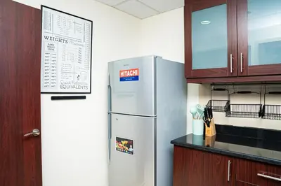 a kitchen with a stainless steel refrigerator and cabinets at Luxury Casa - Platinum Sea View Apartment 2BR at JBR Beach in Dubai