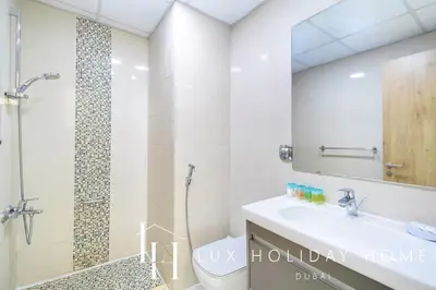 a bathroom with a shower and a toilet and a sink at LUX Marina View Prime Location Near Beach in Dubai