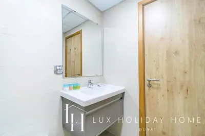 a bathroom with a sink and a mirror at LUX Marina View Prime Location Near Beach in Dubai