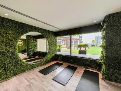 a room with a wall covered in ivy at Luxury Burj Khalifa View Studio Elite Downtown - 18AB19AB03 in Dubai