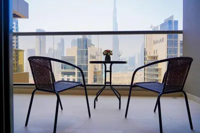 a table and two chairs in front of a window at Luxury Burj Khalifa View Studio Elite Downtown - 18AB19AB03 in Dubai