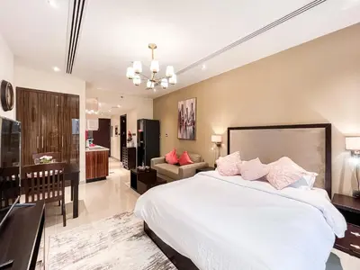 a bedroom with a large bed and a living room at Luxury Burj Khalifa View Studio Elite Downtown - 18AB19AB03 in Dubai