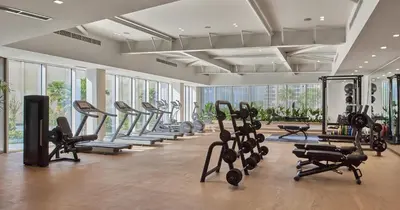 a gym with a bunch of exercise bikes and treadmills at Studio with City Views, Jumeirah Lake Towers - Mint Stay in Dubai