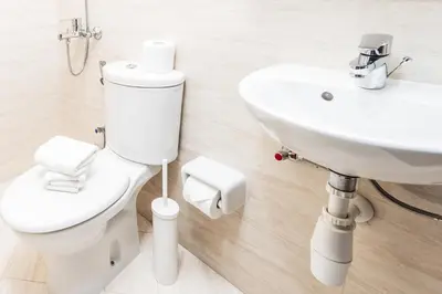 a bathroom with a toilet and a sink at Beautiful & Bright 2BR + kids - 7min to Dubai Mall in Dubai