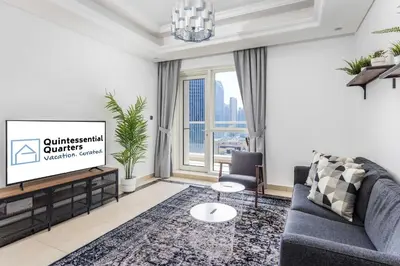 a living room with a couch and a tv at Beautiful & Bright 2BR + kids - 7min to Dubai Mall in Dubai