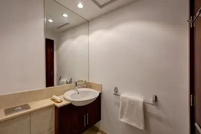 a bathroom with a sink and a mirror at Durrani Homes - Luxe Living with Burj Khalifa and Fountain View - third room without partition in Dubai