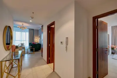 a hallway with a dining room and a living room at Durrani Homes - Luxe Living with Burj Khalifa and Fountain View - third room without partition in Dubai