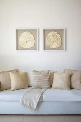 a white couch with pillows on a white wall at Frank Porter - Grand Horizon in Dubai