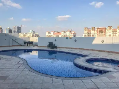 a swimming pool on the roof of a building at Frank Porter - Grand Horizon in Dubai