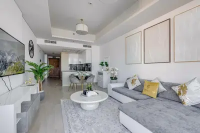 a living room with a couch and a table at GlobalStay Azizi Mina Beachfront Apartments Palm Jumeirah in Dubai