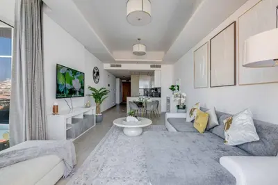 a living room with a couch and a table at GlobalStay Azizi Mina Beachfront Apartments Palm Jumeirah in Dubai