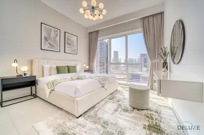 a bedroom with a bed and a large window at Deal of the Week Stylish 1BR with Partial Burj Views by Deluxe Holiday Homes in Dubai
