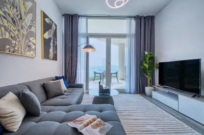 a living room with a couch and a television at GlobalStay Royal Bay Beachfront Apartments Palm Jumeirah in Dubai