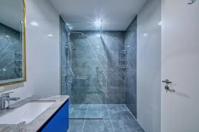 a bathroom with a shower and a sink at GlobalStay Royal Bay Beachfront Apartments Palm Jumeirah in Dubai