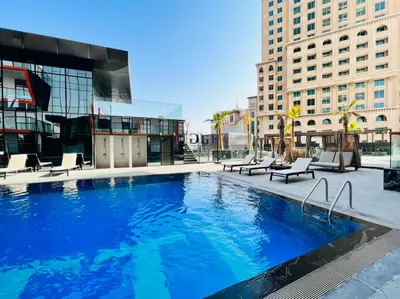 a large swimming pool in a city with buildings at Prime 1BR at Binghatti Avenue Al Jaddaf by Deluxe Holiday Homes in Dubai
