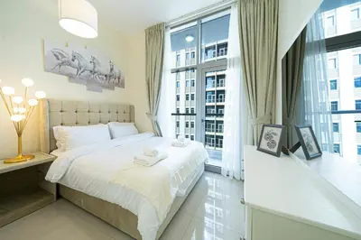 a bedroom with a bed and a large window at Dubai Marina Royal Premium Serviced Apartments Marina Wharf - KIDS STAY FREE plus free check in 24 hours in Dubai