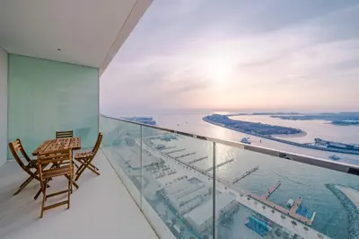 a balcony with a chair and a view of the ocean at Breathtaking Atlantis view, Spacious 2BR on beach in Dubai