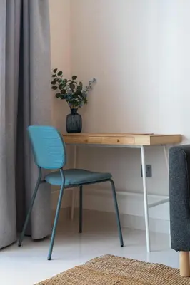 a desk with a chair and a vase on it at Breathtaking Atlantis view, Spacious 2BR on beach in Dubai