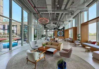 a lobby with a lot of furniture and windows at First Class Apartments in Dubai Hills - Next to Dubai Hills Mall - Socio, Collective and Golfville Towers in Dubai