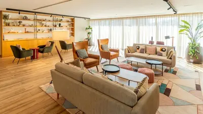 a living room with couches and chairs at First Class Apartments in Dubai Hills - Next to Dubai Hills Mall - Socio, Collective and Golfville Towers in Dubai