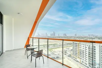 a balcony with two chairs and a view of the city at Harmonious 1BR at Binghatti Avenue Al Jaddaf by Deluxe Holiday Homes in Dubai