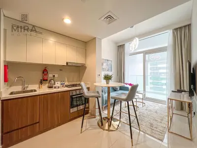 a kitchen with a table and chairs in a room at Mira Holiday Homes - Newly furnished 1 bedroom in Business Bay in Dubai