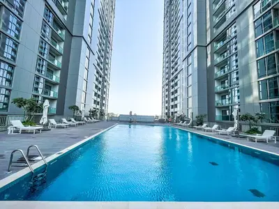 a large swimming pool in the middle of two tall buildings at STAY BY LATINEM Luxury 1BR Holiday Home CV A107 near Burj Khalifa in Dubai