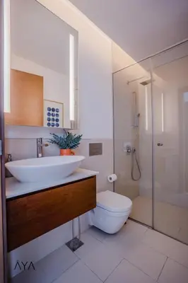 a bathroom with a sink and a toilet and a shower at Luxury Apartment with Pool, Patio & Gym in City Walk By ĀYA Boutique in Dubai