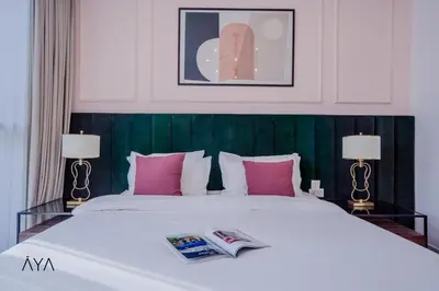 a bedroom with a large white bed with pink pillows at Luxury Apartment with Pool, Patio & Gym in City Walk By ĀYA Boutique in Dubai