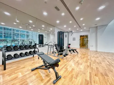 a gym with several treadmills and exercise bikes at The Smart Concierge - Waves by Kasco in Dubai