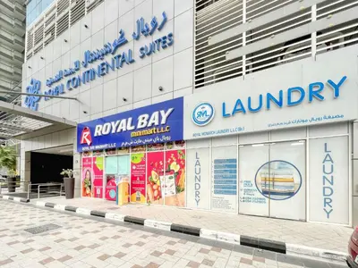 a building with signs on the side of it at The Smart Concierge - Waves by Kasco in Dubai