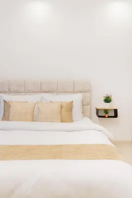 a bedroom with a large white bed with pillows at The Smart Concierge - Waves by Kasco in Dubai