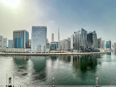 a view of a city with a river and buildings at The Smart Concierge - Waves by Kasco in Dubai